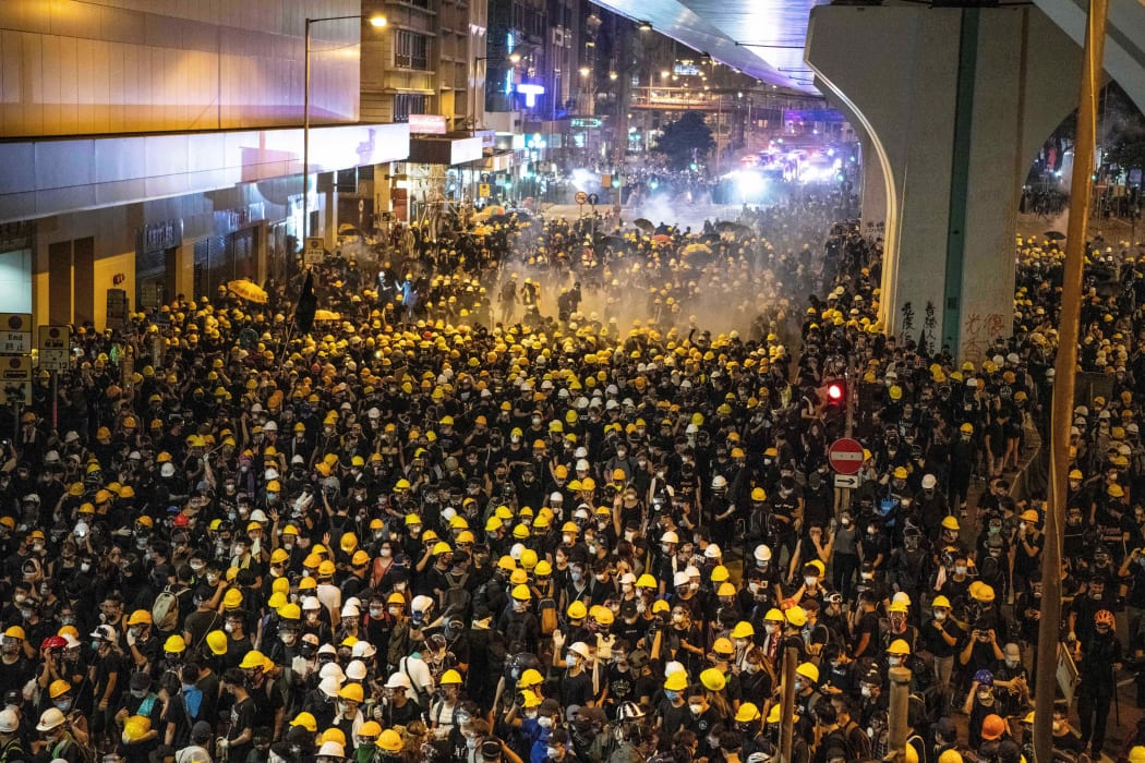 Police fire tear gas at protesters to disperse them after a march against a controversial extradition bill in Hong Kong on July 21, 2019.