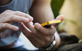 lifestyle young man using a mobile phone with texting message on app smartphone, playing social network and shopping online