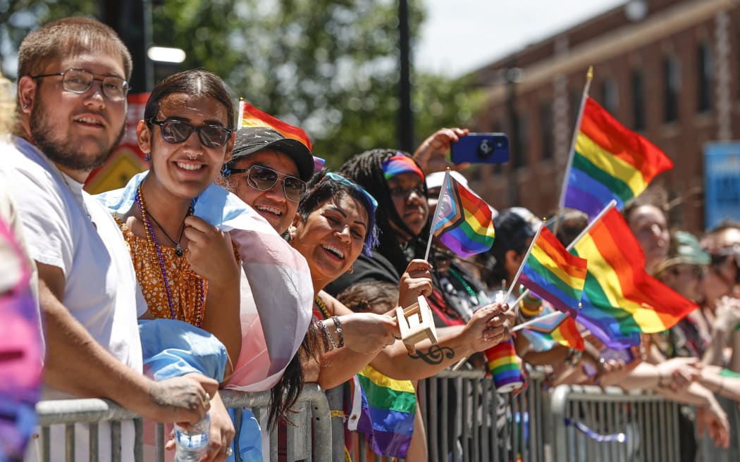 People wave rainbow flags during the 51st LGBTQ Pride Parade in Chicago, Illinois, on 26 June, 2022.