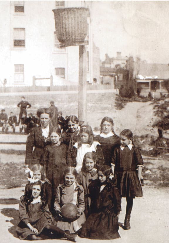 Early photo of school netball in New Zealand. Normal School, Wellesley Street, Auckland. Believed to be taken around 1908.