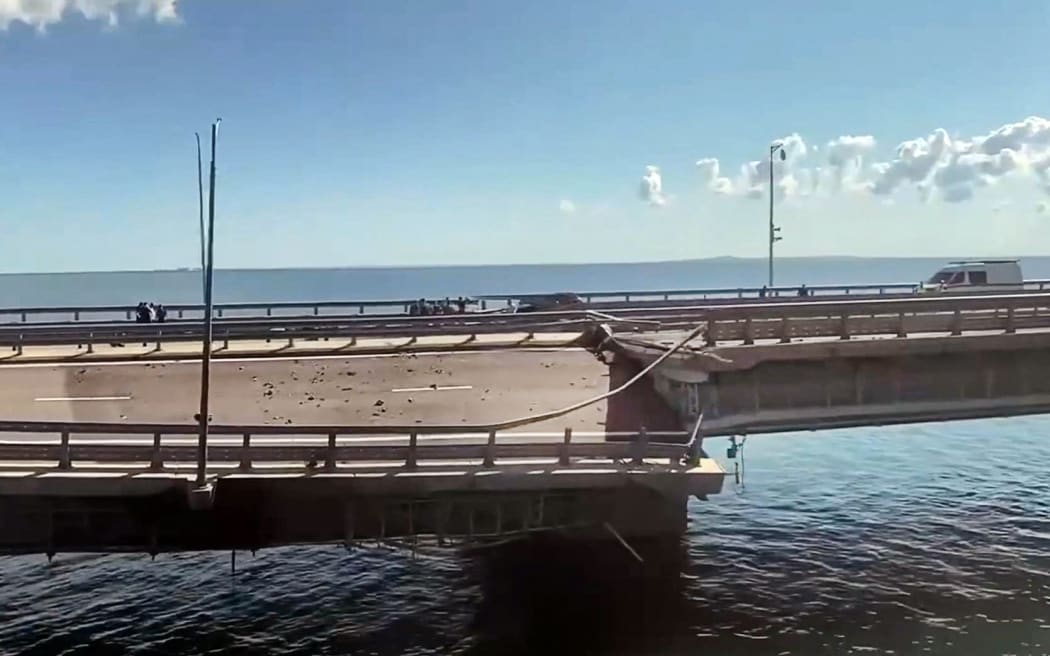 This video grab taken from a ?rimea24TV footage on July 17, 2023 shows the damaged Kerch bridge -- linking Crimea to Russia -- which was heavily damaged following an attack. Russia on July 17, 2023, said a Ukrainian attack on the bridge linking Moscow-annexed Crimea to the Russian mainland killed a civilian couple and wounded their child. Moscow said two drones had hit the bridge in the early hours and blamed "the Kyiv regime." (Photo by Crimea24TV / AFP)