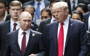 (FILES) November 11, 2017 US President Donald Trump and Russian President Vladimir Putin make their way to  the "family photo" during the APEC leaders' summit in Danang, Vietnam.