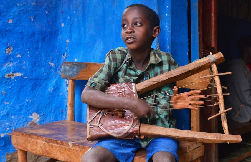 A boy playing a Krar
