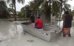 Tuvalu - locals assessing damage following flooding
