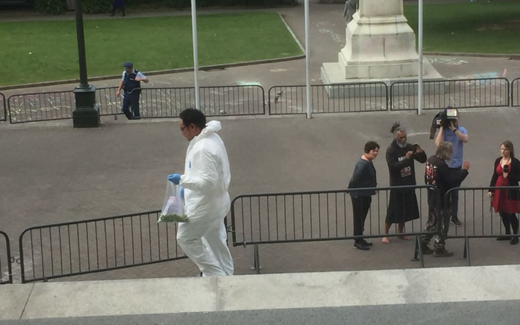 Men in HAZMAT outfits pick up 1080 look-alike pallets
