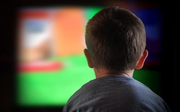 A close-up of a child watching television
