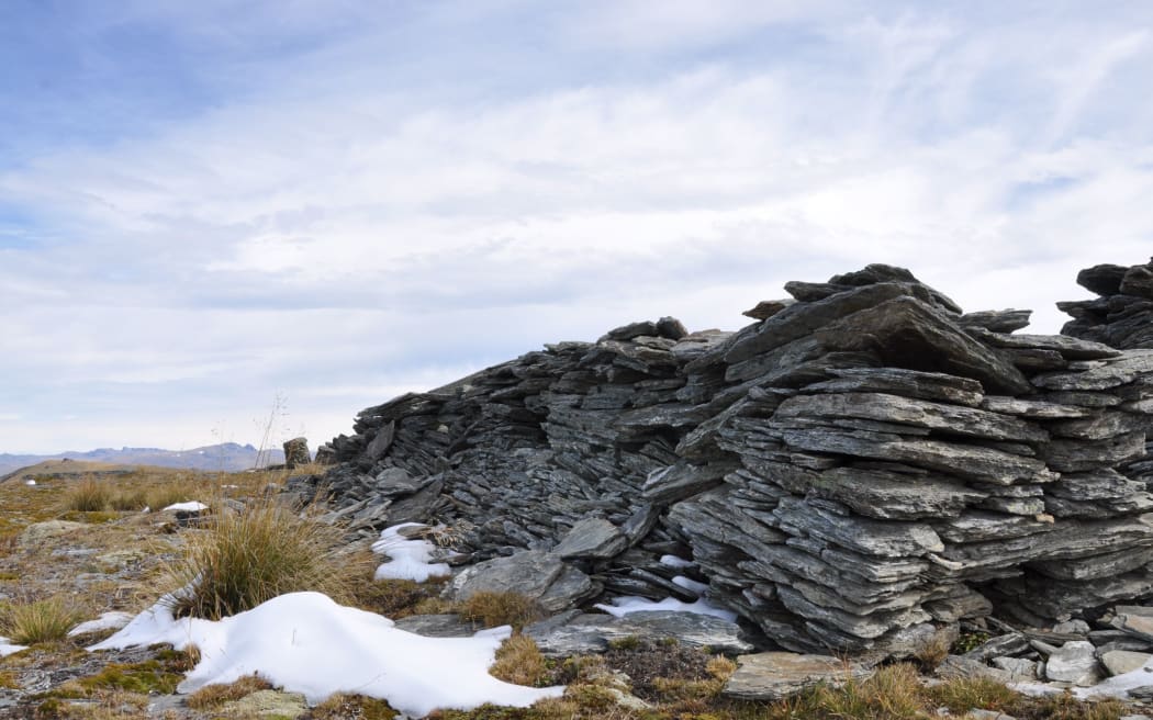 The remains of a miner's schist hut are slowly succumbing to the elements on Old Man Range. This photo was taken in March, and the snow in the foreground is from two days earlier.