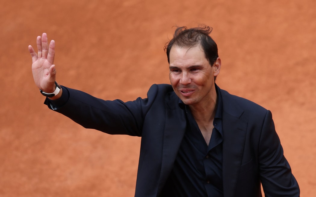 Former Spanish player Rafael Nadal waves to the spectators at the end of a ceremony honouring his career on Court Philippe-Chatrier during the French Open tennis tournament at Roland-Garros, 25 May 2025.