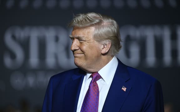 US President Donald Trump arrives to address troops at the Al-Udeid air base southwest of Doha on May 15, 2025. (Photo by Brendan SMIALOWSKI / AFP)