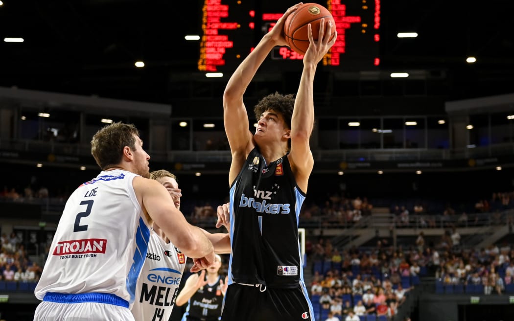 Karim Lopez of the Breakers  is blocked by Robert Loe of Melbourne United