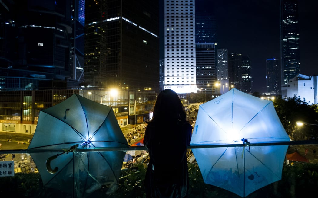 Pro-democracy demonstrators stood divided on Sunday over whether to withdraw from protest sites across Hong Kong.