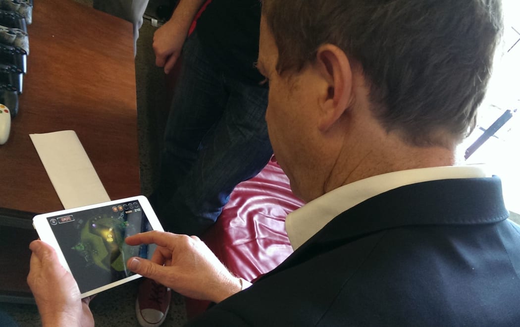 Green Party co-leader Russel Norman playing a video game during party's IT policy launch