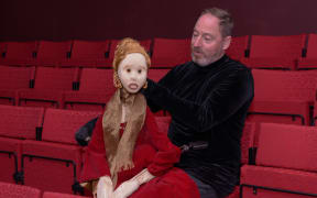 Puppeteer Kenny King sits next to the puppet 'Lady'.