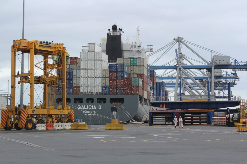 Cranes and container movers work to laod a ship at the Ports of Auckland