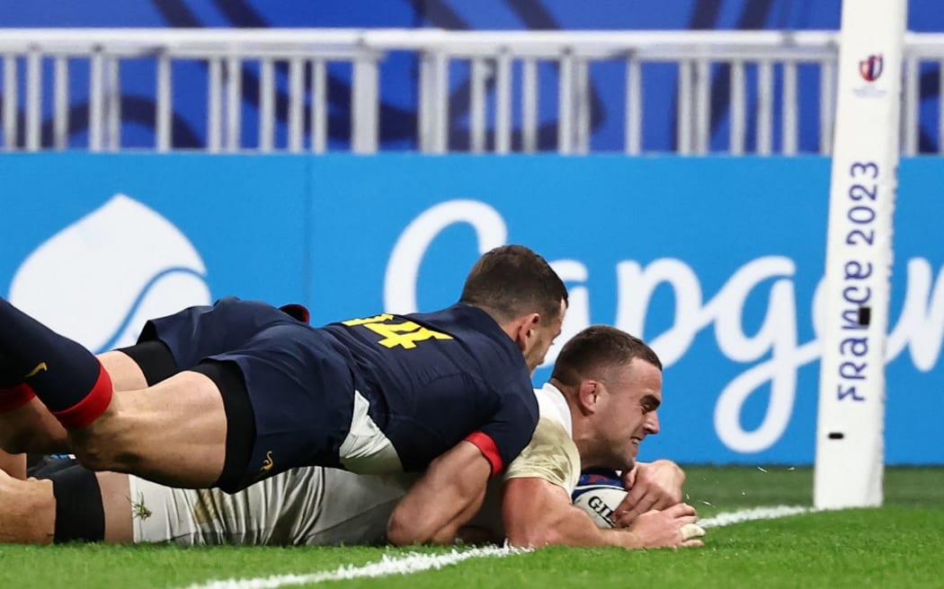 England's number eight Ben Earl scores a try a he is tackled by Argentina's Emiliano Boffelli  during the 2023 Rugby World Cup third-place match at the Stade de France in Saint-Denis.