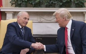 Donald Trump shakes hands with newly sworn-in White House chief of staff, retired General John Kelly.