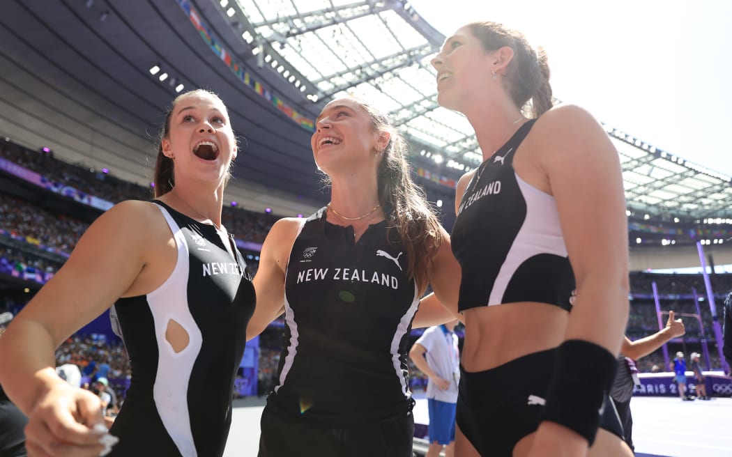 Olivia McTaggart (NZL) (L), Imogen Ayris (NZL) (C) and Eliza McCartney (NZL) celebrate together after qualifying for the Women's Pole Vault Final at Stade de France during the 2024 Paris Olympics.