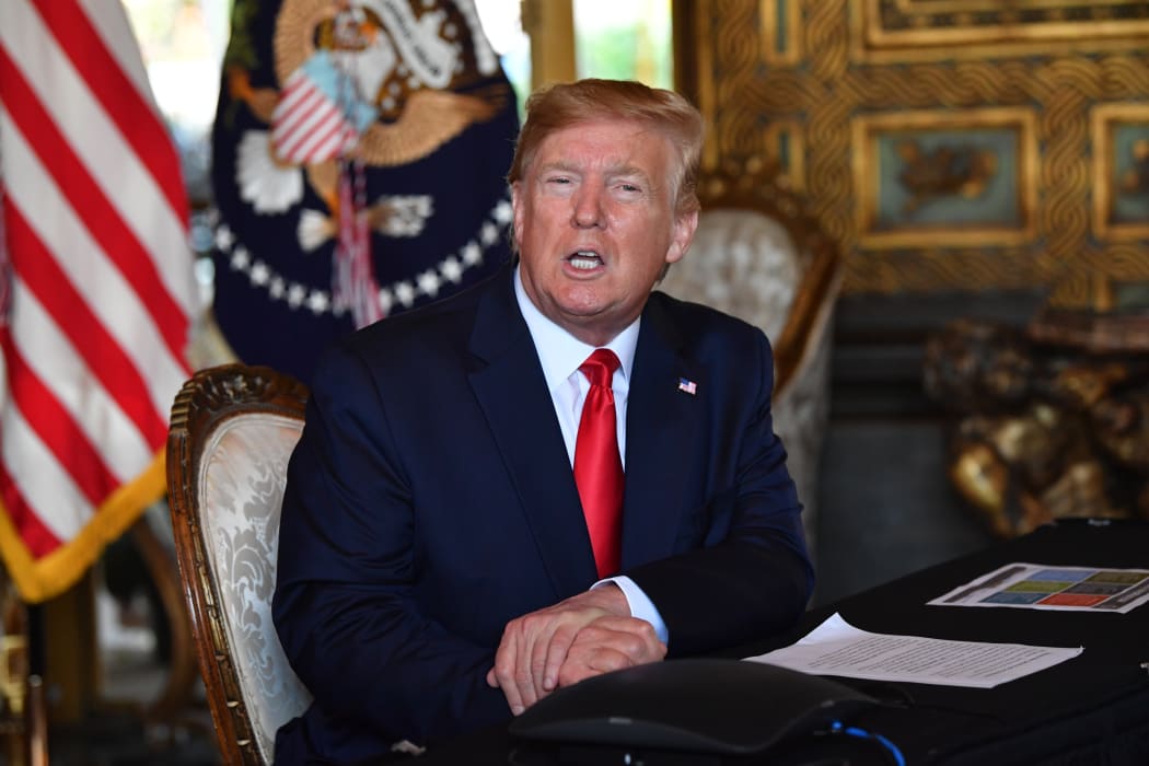 US President Donald Trump answers questions from reporters after making a video call to the troops stationed worldwide at the Mar-a-Lago estate in Palm Beach, Florida.