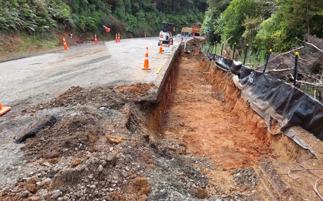Trenching alongside SH1 at the end of a slip at the northern end of Mangamuka Gorge.