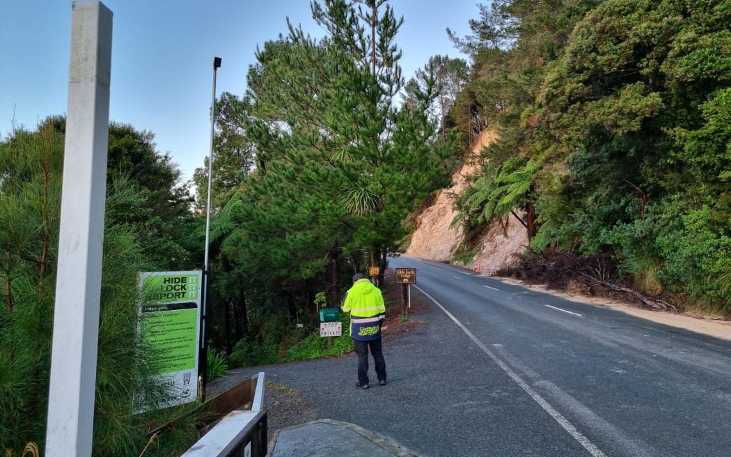 A security guard at the entrance to Abbey Caves, Northland, where a body was recovered during a search for a Year 11 student from Whangārei Boys' High School missing on a trip into the caves with a school party.