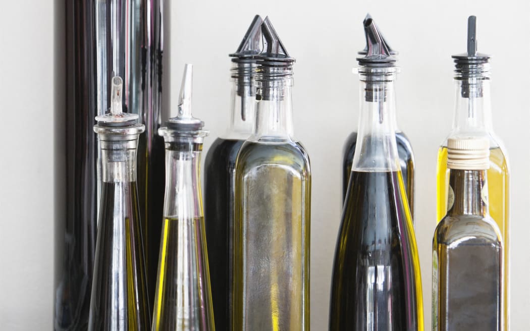 Assorted cooking oil bottles in a restaurant (Photo by Fabrice Lerouge / Onoky / Photononstop via AFP)