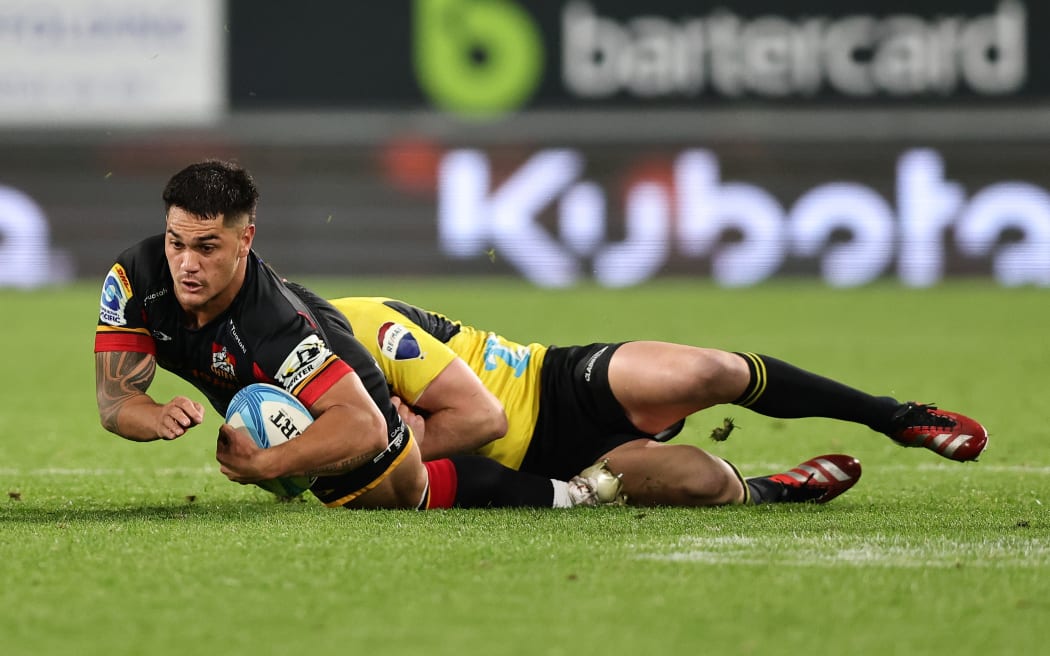 Chiefs midfielder Quinn Tupaea is tackled.