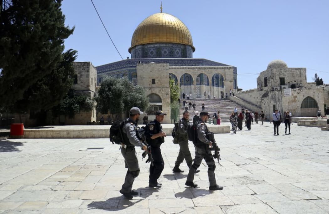 Israeli police walk past the Dome of the Rock in the compound known to Muslims as al-Haram al-Sharif (Noble Sanctuary) and to Jews as Temple Mount, in May.