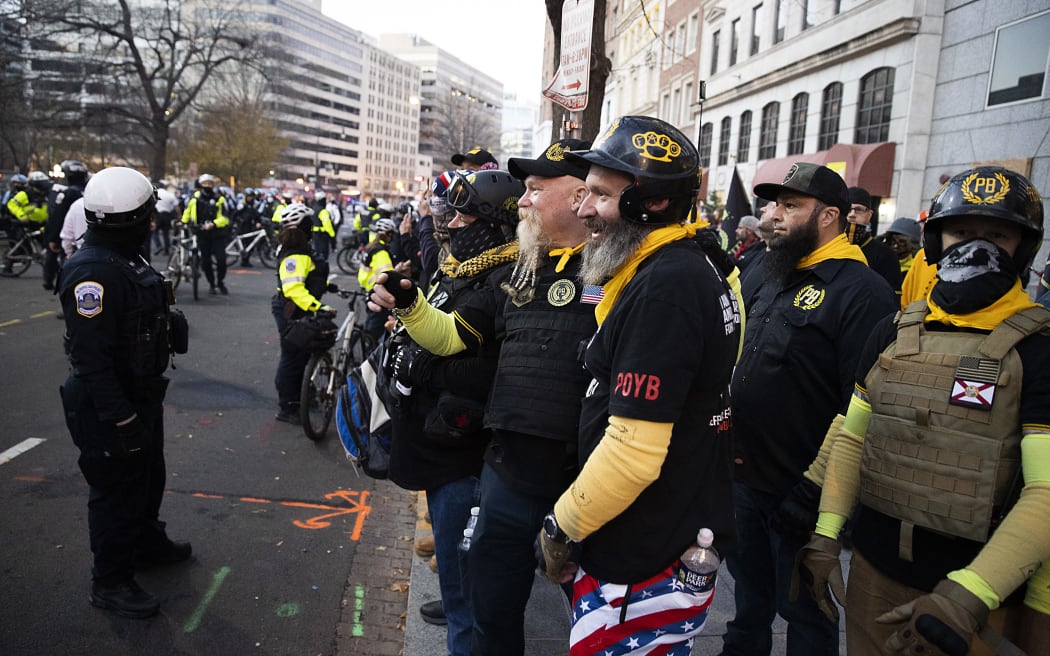 WASHINGTON, DC - DECEMBER 12: Members of the Proud Boys in Washington DC on 12 December, 2020 gather among thousands of protesters who refused to accept Donald Trump's election loss to Joe Biden. (Photo by TASOS KATOPODIS / GETTY IMAGES NORTH AMERICA / Getty Images via AFP)