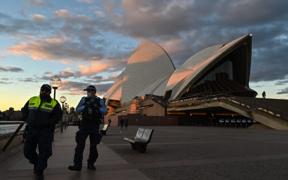 SYDNEY, AUSTRALIA - JUNE 26: Police officers walk past The Sydney Opera House during the first day of lockdown in Sydney, Australia, Saturday, June 26, 2021.