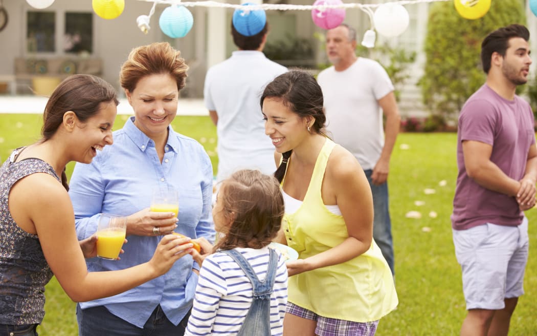 33550343 - multi generation family enjoying party in garden together