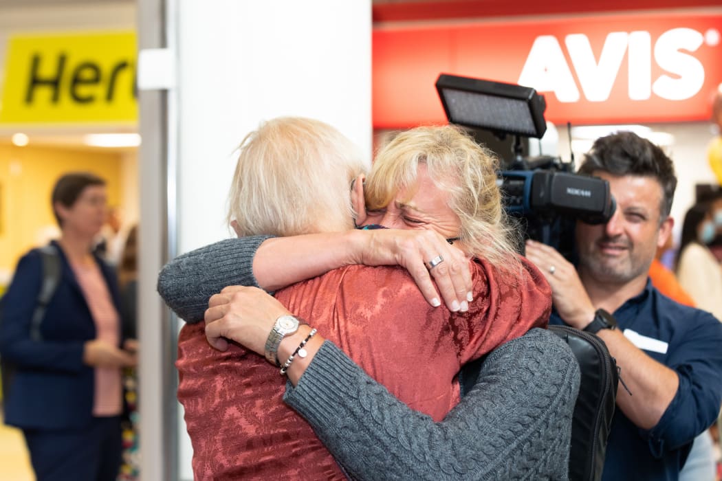 A passenger on the first quarantine-free flight into Auckland embraces with a loved one