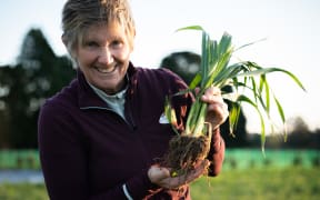 Jules Matthews, a director at Mangaroa Farms, holding some of the vegetables she has grown.