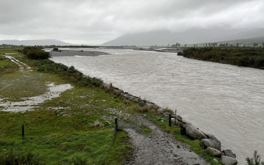 Supplied/West Coast Regional Council

[Wanganui stopbank damage] A view upriver towards the State Highway 6 bridge following the August storm which took out chunks of the northern bank stop bank, left.
