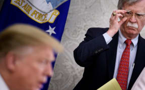 National Security Advisor John R. Bolton listens while US President Donald Trump speaks to press.