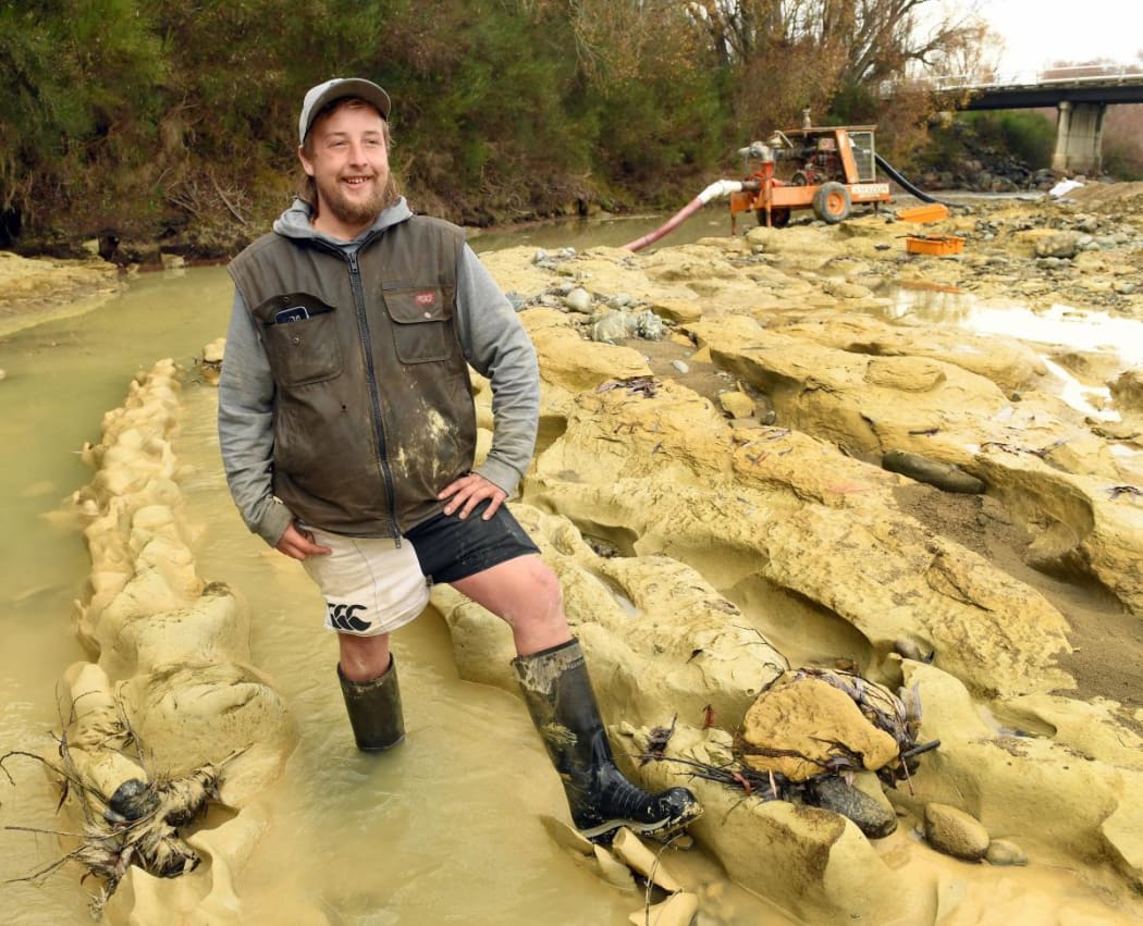 Michael Johnston at the riverbed site where preparations are being made to remove the the fossilised moa footprints he discovered .