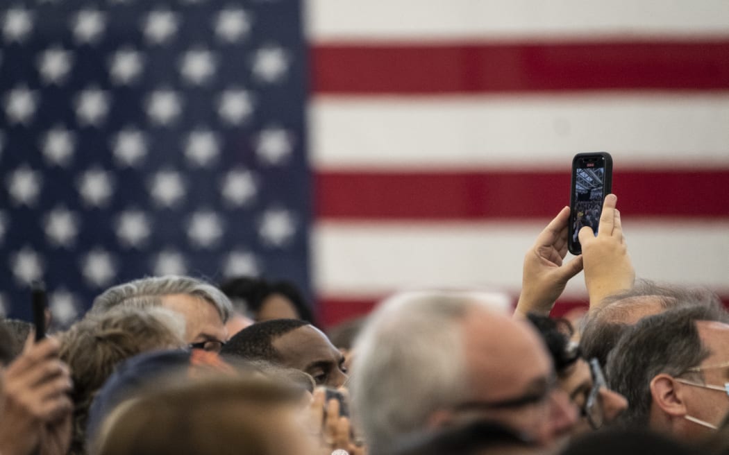 DETROIT, MI - OCTOBER 29: An attendee films former President Barack Obama during a campaign rally for Michigan Democrats at Renaissance High School on October 29, 2022 in Detroit, Michigan. Former President Obama has been campaigning for Democratic candidates in key states ahead of the midterm election.   Matthew Hatcher/Getty Images/AFP (Photo by Matthew Hatcher / GETTY IMAGES NORTH AMERICA / Getty Images via AFP)