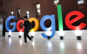 A guy walks past the Google logo set up for the Google Developers Day in Shanghai, China, 10 September 2019.