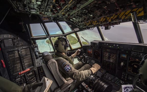 Pilot FLTLT Michal-Louise Paget flies over Etal Atoll, Chuuk, Micronesia as part of Operation Christmas Drop.