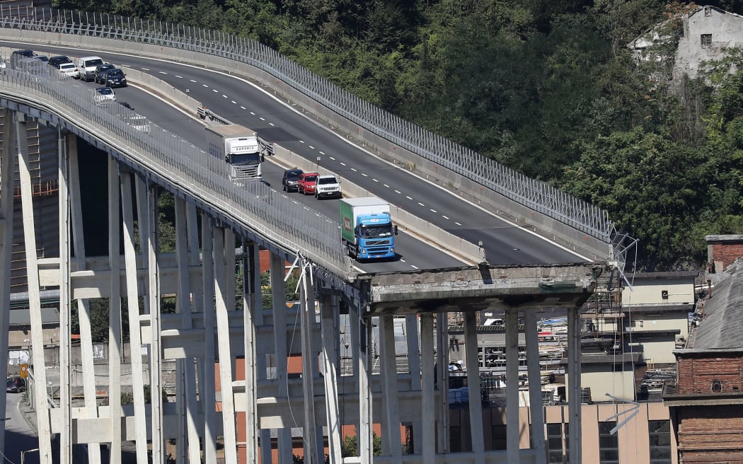 Vehicles on the Morandi motorway bridge the day after a section collapsed in the north-western Italian city of Genoa.