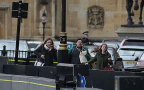 People run from the scene outside the Houses of Parliament.