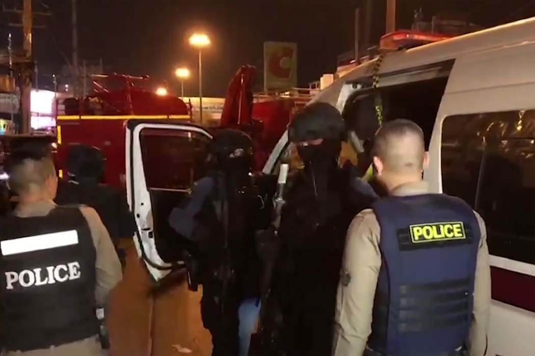 A video grab from a handout video released by the MCOT Thai Public Company Limited shows Thai police arriving at the scene of a mass shooting in the northeastern city of Nakhon Ratchasima.
