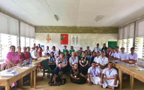 Mary Jane Kivalu (sitting on the floor at left) with the University of Otago delegation at Takuilau College in Lapaha, Tonga