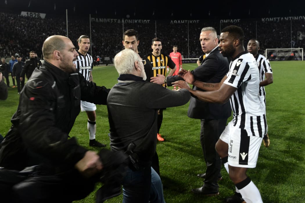 Paok president Ivan Savvidis takes to the pitch carrying a handgun in his waistband, after the referee refused a last minute goal on Sunday.