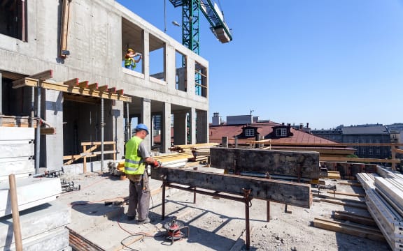 workers with power tools on the building site
