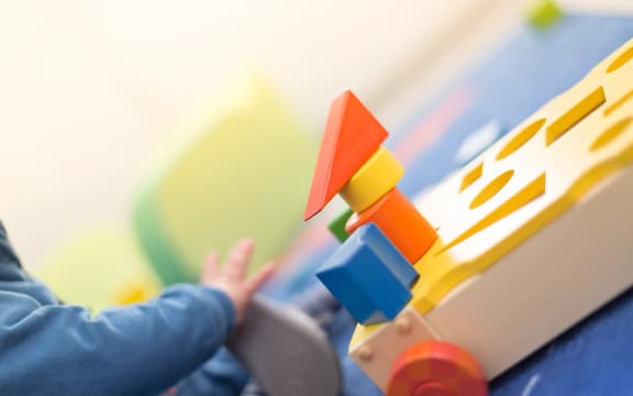 Cute and happy baby playing with his toys, early childhood education generic, daycare, pre-school, kindergarten