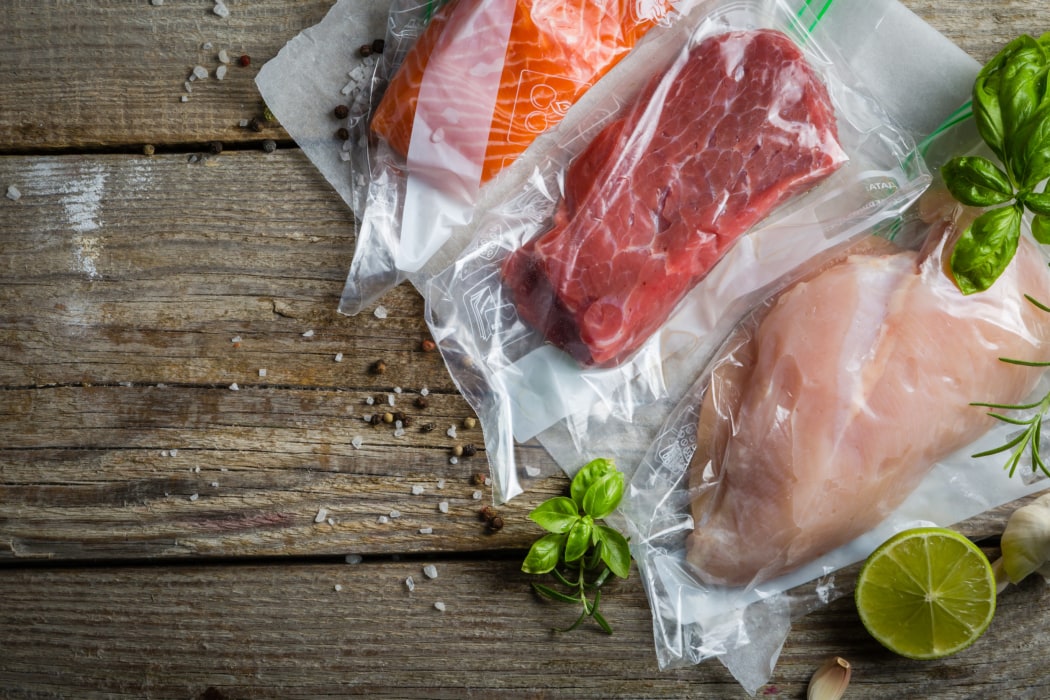 Beef, chicken and salmon in vacuum plastic bag for sous vide cooking, copy space