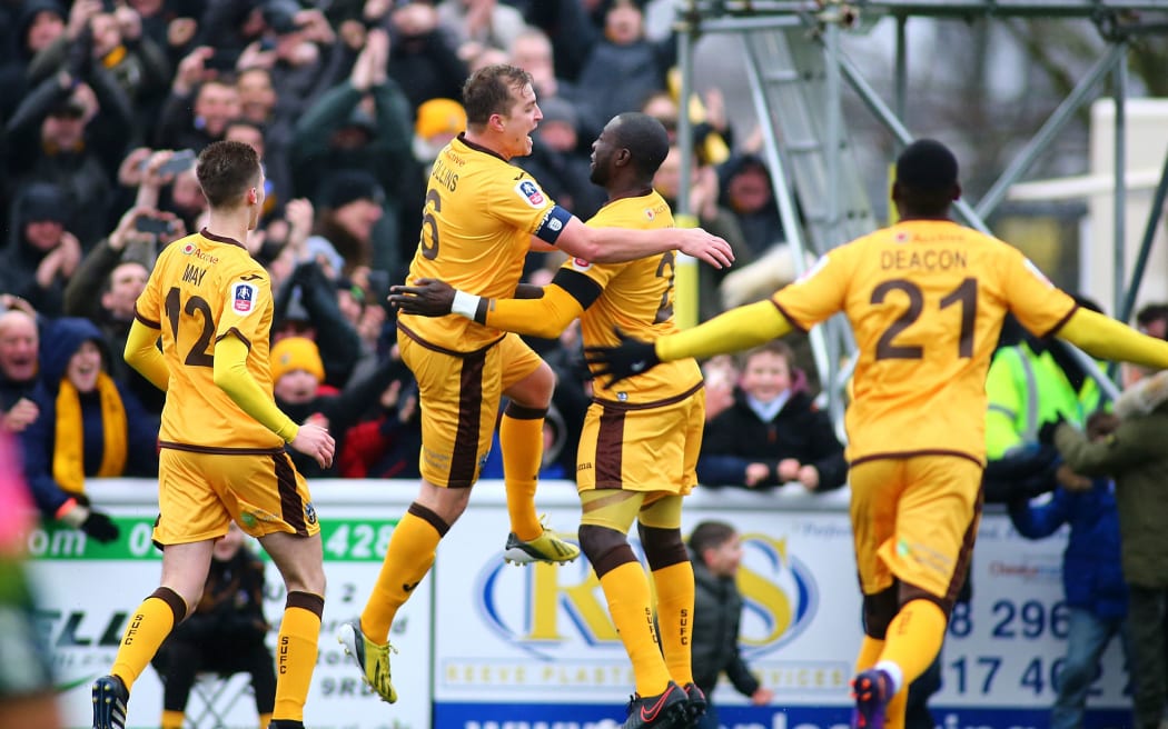 Sutton United players celebrate.