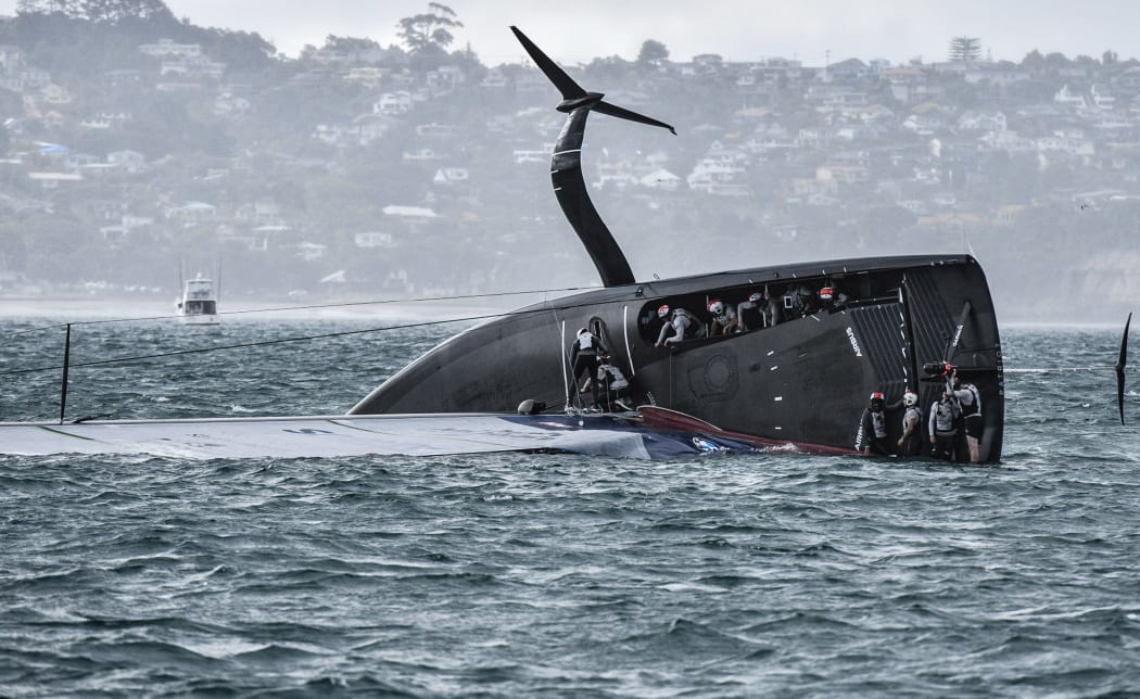 American Magic capsized just before the final leg in race three of the Prada Cup.