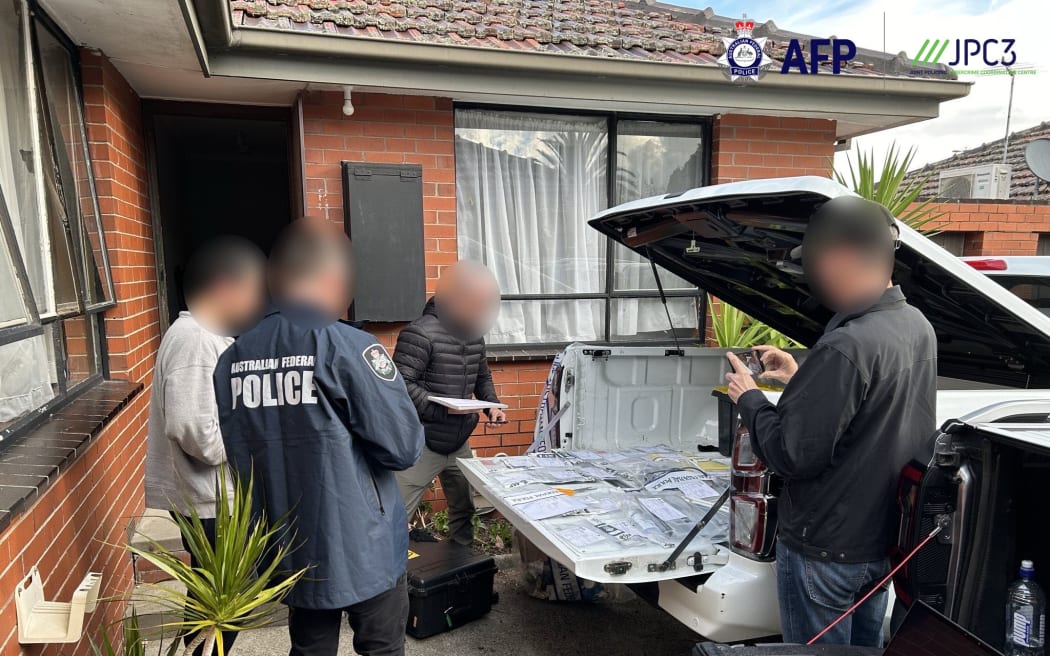 Australian police officers carry out a search warrant in relation to investigations into the LabHost plaform.