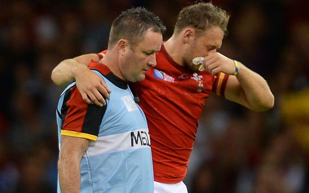 Cory Allen is helped from the field after being injured in his side's RWC over Uruguay.